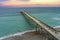 aerial shot of Johnnie Mercer\\\'s Fishing Pier with vast blue ocean water and people walking along the pier