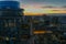 Aerial shot of the JW Marriott building and office buildings in the city skyline at sunset with cars driving on the street