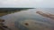 Aerial Shot of Kiteboarders and Kitesurfers of the Baltic Sea Autumn Day. Man Kiteboarding and Jumping  on a Kite Board