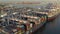 Aerial shot of large, commercial ships docked in the port of Long Beach