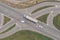 Aerial shot of large semi-truck, a van and a pickup truck on road intersection from drone pov