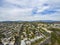 Aerial shot of the lush green trees, grass and plants at Lincoln Park with homes, apartments and mountain ranges and cars driving