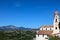 Aerial shot of lush scenery and the Church of Saint James against the blue sky in Lauria, Italy