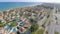 Aerial shot of luxury cottages along coastline. Top view of beautiful seascape
