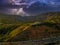 An aerial shot of the majestic mountain ranges with homes along the coastline of California, freeways with cars