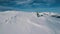 Aerial shot male active sports man climbing on top of snow mountain making snowboarding