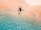 Aerial shot of man relaxing in a kayak Summer seascape beach and blue sea water Top view from drone