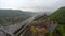 Aerial shot medieval castle, old fortress on river dam, city