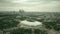 Aerial shot of Moscow cityscape involving famous Luzhniki football stadium and distant business center skyscrapes