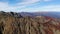 Aerial shot of mountains. Mountains, peaks, cliffs, rocks, ridges, landscape, green grass, sky, clouds, nature