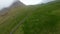 Aerial shot of Mulafossur waterfall and a cliffed coast in Vagar, Faroe Islands