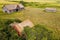 Aerial shot of an old abandoned wooden homestead with the field in the background in Glenside Canada
