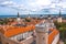 Aerial shot of the old town of Tallinn with orange roofs, churches\' spires and the Toompea castle