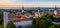 Aerial shot of the old town of Tallinn with orange roofs, churches\' spires and the Toompea castle