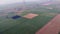 aerial shot of open countryside posing as a beautiful tapestry of green and brown checks