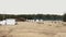 Aerial shot over sand beach. People laying on bean bags, playing sport games