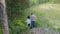 Aerial shot of a pair of young people walking along a forest path.