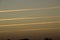 Aerial shot of plane traces in the sky at sunset