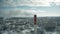 Aerial shot of a red and white smokestack in urban environment in winter