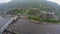 Aerial shot of river dam, small village mountains, car traffic