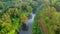 Aerial Shot Of river and trough and trees tinged in autumn colors