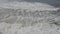 Aerial shot of rough ocean waves crashing against rocks on beach in Portugal