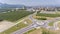 Aerial shot of a roundabout at the entrance to a small town with farmlands in Slovenia