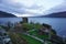 Aerial shot of the ruins of Urquhart Castle, Edinburgh under cloudy sky