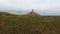 Aerial shot of a sandstone pillar in the green field at Chimney Rock National Historic Site Nebraska