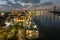 aerial shot of the Savannah River at sunset with the Talmadge Memorial Bridge, ships docked along the banks with restaurants