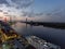 aerial shot of the Savannah River at sunset with the Talmadge Memorial Bridge, ships docked along the banks with restaurants