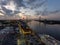 aerial shot of the Savannah River at sunset with the Talmadge Memorial Bridge, ships docked along the banks with restaurants