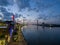 aerial shot of the Savannah River at sunset with the Talmadge Memorial Bridge, ships docked along the banks with restaurants