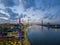 aerial shot of the Savannah River at sunset with the Talmadge Memorial Bridge, ships docked along the banks with restaurants