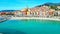 Aerial shot of a scenic coastal landscape showcasing a picturesque beach and a quaint seaside town.