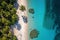 Aerial shot of a secluded tropical beach with crystal clear water, palm trees, and a couple of beach chairs. Perfect for