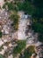 Aerial shot of the semi demolished buildings surrounded by trees