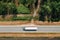 Aerial shot of semi-truck driving along the highway through countryside landscape, drone pov directly above. Transportation and