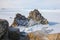 Aerial shot of Shamanka rock on Olkhon island in winter. Frozen lake Baikal in daylight, Siberia, Russia. Drone flies above