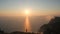 Aerial shot of the silhouette of an active tourist standing on the edge of a high mountain above the Black Sea. A