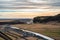 an aerial shot of the Skogafoss waterfall river surrounded by the field and cars