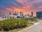 aerial shot of skyscrapers, office buildings and State Farm Arena in the city skyline with lush green trees, billboards