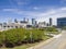 aerial shot of skyscrapers, office buildings and State Farm Arena in the city skyline with lush green trees, billboards