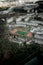 Aerial shot of a soccer field surrounded by trees in a park and buildings in Vilnius, Lithuania