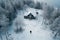 Aerial shot of solitary figure near cabins in snowy Sweden