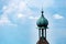 Aerial shot of a spire of a building against a blue sky in Freiburg im Breisgau city in Germany.