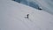 Aerial shot sports man wearing snowboarding equipment ride on track at ski resort surrounded by snow