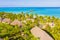 Aerial shot of the Stilt hut with palm thatch roof washed with turquoise Indian ocean waves on the white sand sandbank beach on