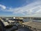 An aerial shot of a stunning sunrise over Mobile Bay with buildings, shipping cranes, ships docked and a gorgeous blue sky