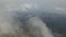 Aerial shot of a suburb, the main road, the forest in the clouds. 360 degree swivel.